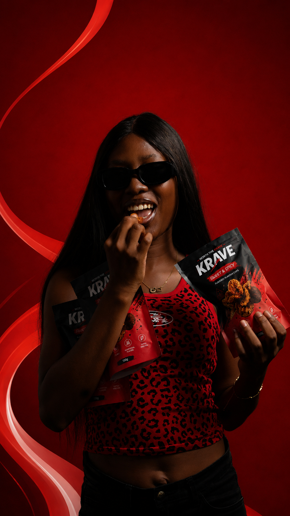 Model holding bags of Krave Sweet & Spicy plantain chips
